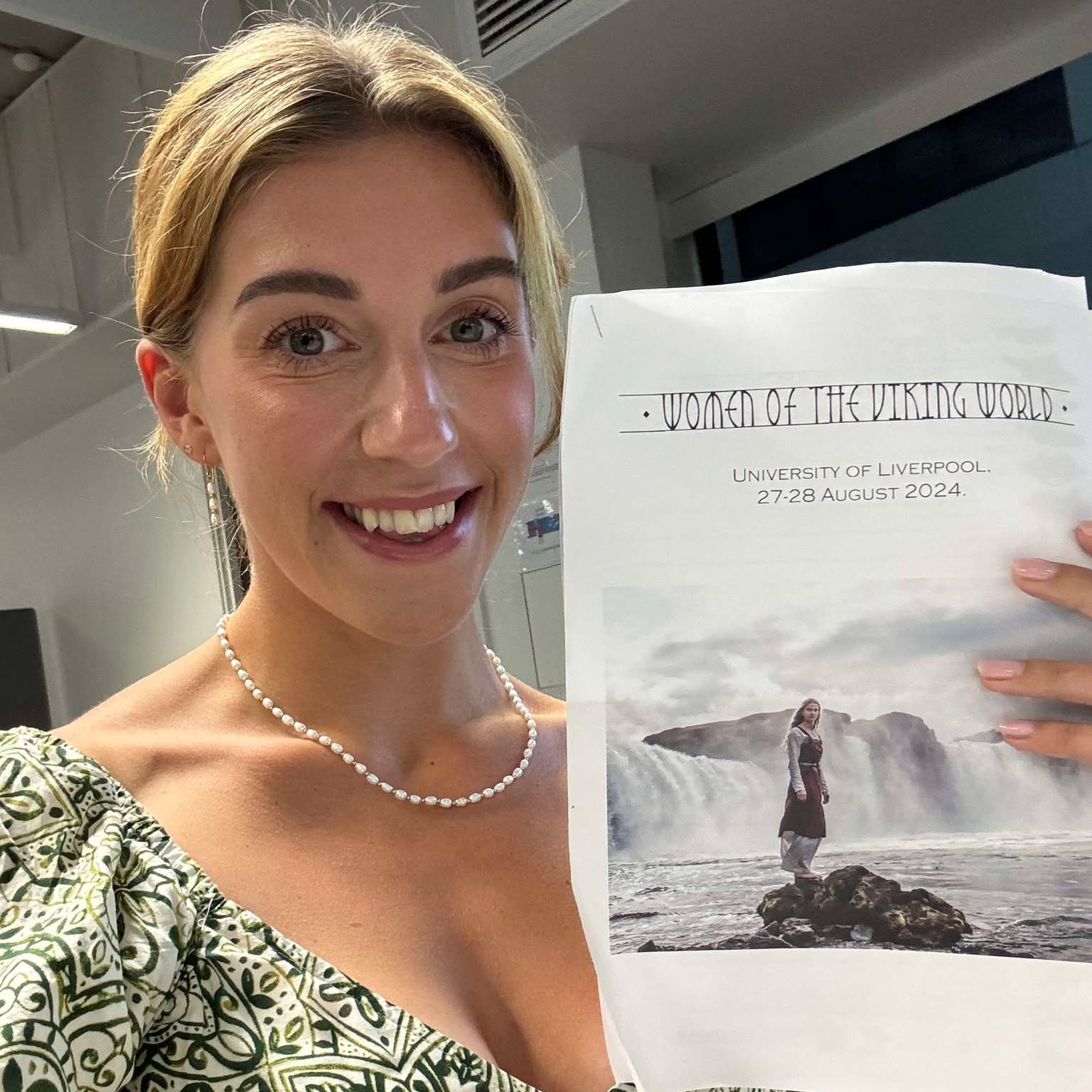 Francesca Squitieri holding the conference schedule whilst attending the 'Women of the Viking World' Conference held at the University of Liverpool in August 2024