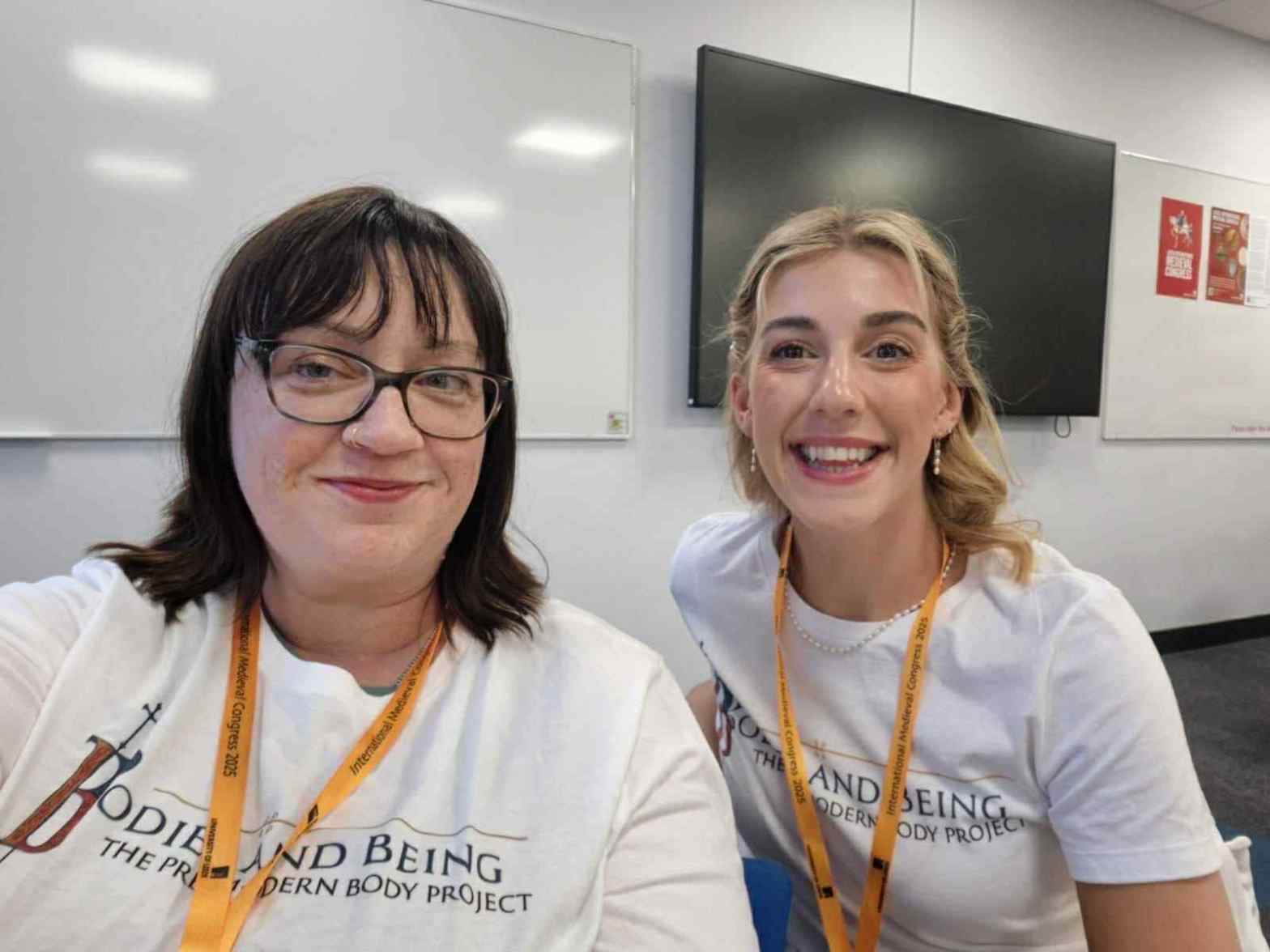 Autumns and Francesca in their bodies and Being t shirts before their roundtable discussion at Leeds IMC